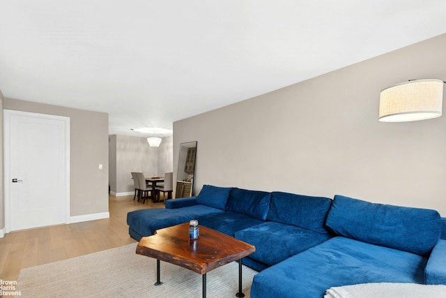 living room featuring baseboards and wood finished floors