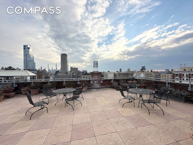 view of patio / terrace with a view of city and outdoor dining space