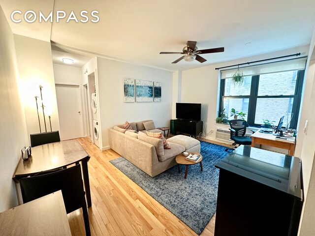 living area featuring light wood-style flooring and a ceiling fan