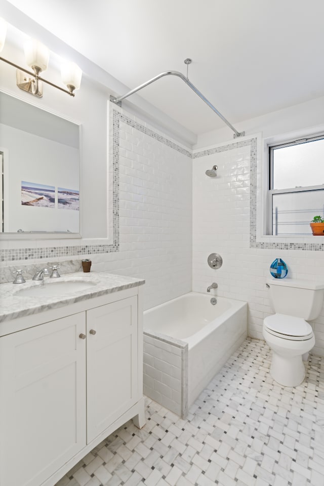 bathroom featuring shower / bath combination, toilet, tile walls, and vanity