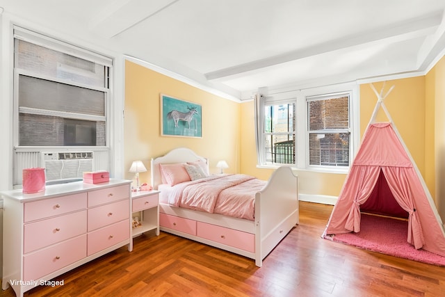 bedroom with cooling unit, beamed ceiling, baseboards, and wood finished floors