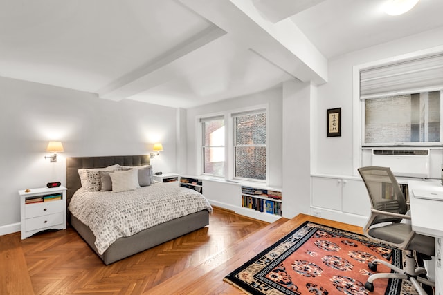 bedroom featuring beamed ceiling and baseboards