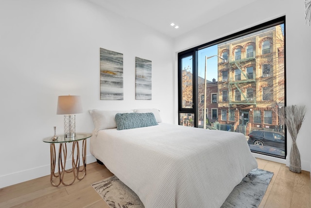 bedroom featuring recessed lighting, light wood-type flooring, and baseboards