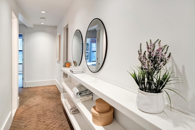 hallway featuring carpet floors, recessed lighting, and baseboards