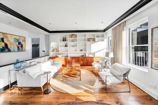 living room with hardwood / wood-style floors, baseboards, and ornamental molding