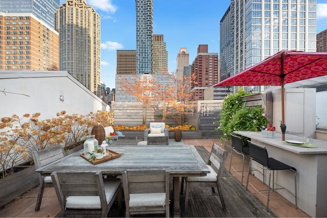 325 W 52nd St Phg, Phg, New York City, NY 10019 - view of patio featuring a view of city, outdoor dining area, fence private yard, and outdoor dry bar