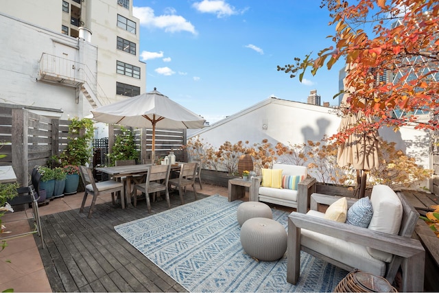 wooden deck with fence, outdoor dining area, and an outdoor living space