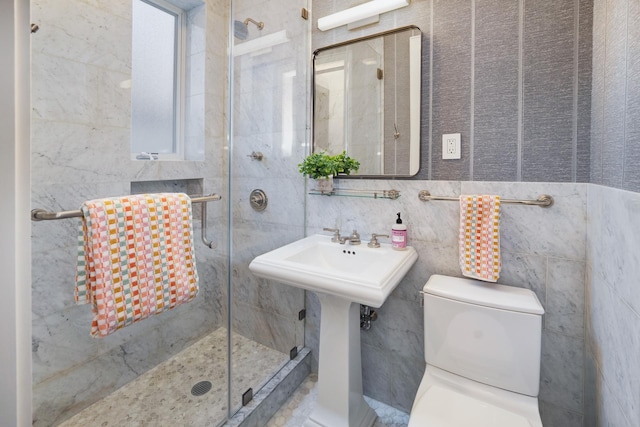 full bathroom with a stall shower, tile walls, and toilet