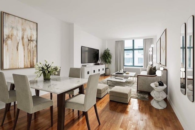 dining space featuring baseboards and wood finished floors