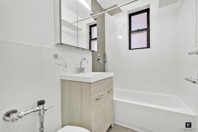 10 E 43rd St Unit 4-K, New York City, NY 11203 - bathroom featuring vanity, tile walls, bathing tub / shower combination, and toilet