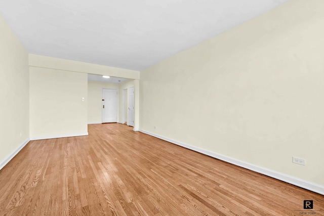10 E 43rd St Unit 4-K, New York City, NY 11203 - spare room featuring baseboards and light wood-style floors