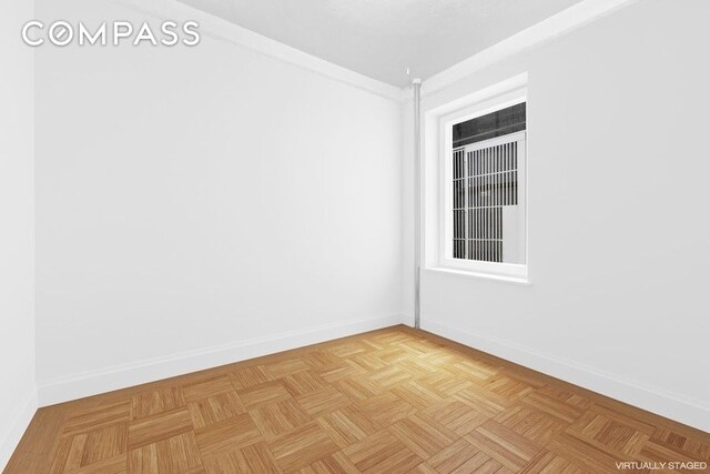 spare room featuring baseboards