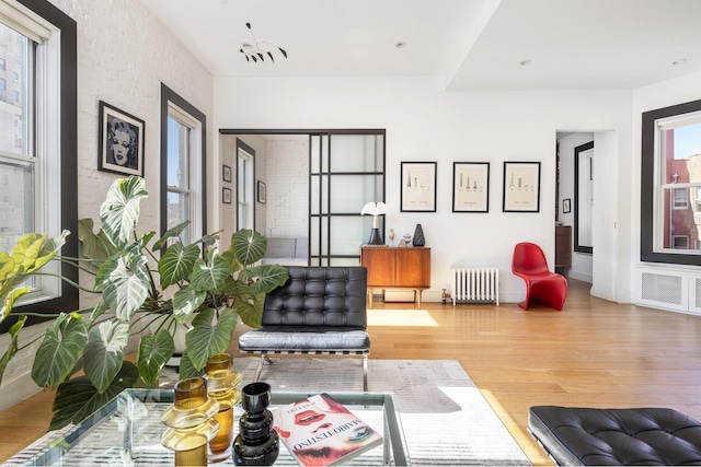 interior space with radiator and wood finished floors