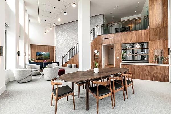 dining area featuring carpet floors, stairs, and a towering ceiling