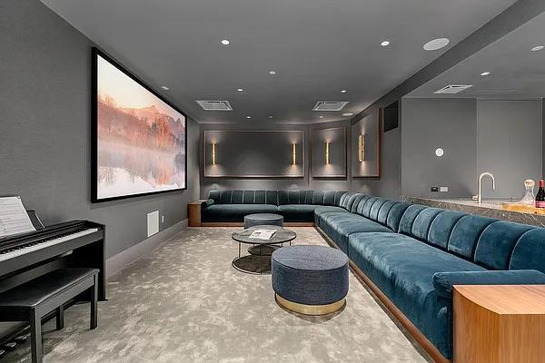 home theater featuring a sink, baseboards, visible vents, and carpet flooring