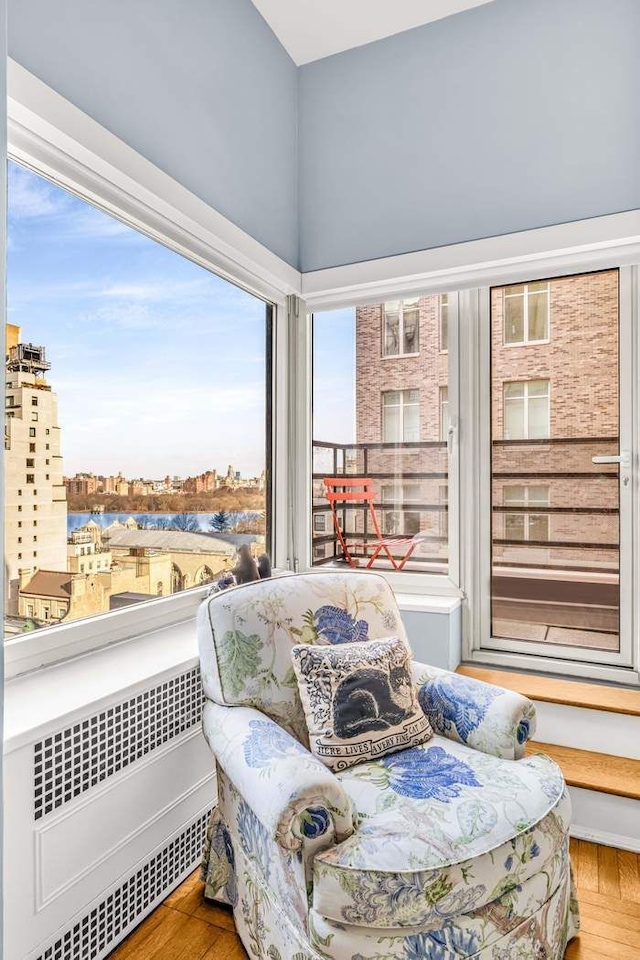 19 E 88th St Unit 15G, New York City, NY 10128 - sitting room with radiator, wood finished floors, and a city view