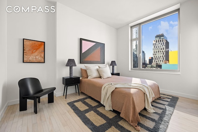 85 W Broadway Unit 14S, New York City, NY 10007 - bedroom with wood finished floors, a skyline view, and baseboards