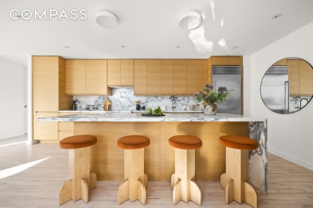 85 W Broadway Unit 14S, New York City, NY 10007 - kitchen featuring stainless steel built in fridge, tasteful backsplash, light wood-style flooring, baseboards, and recessed lighting