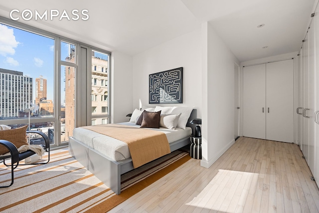 85 W Broadway Unit 14S, New York City, NY 10007 - bedroom featuring light wood-style floors, a view of city, and access to exterior