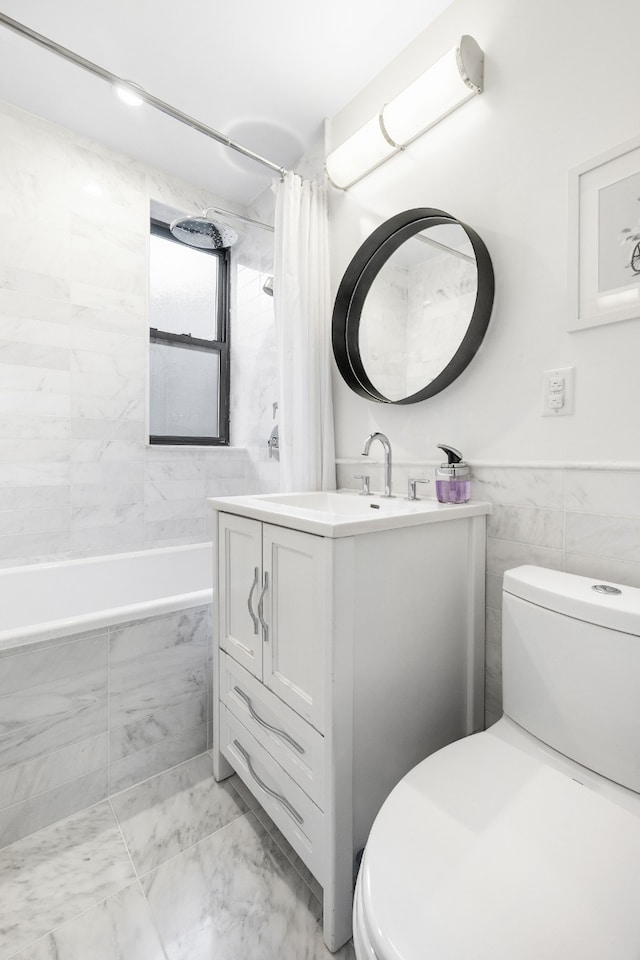 full bathroom featuring marble finish floor, shower / bath combo, toilet, and tile walls