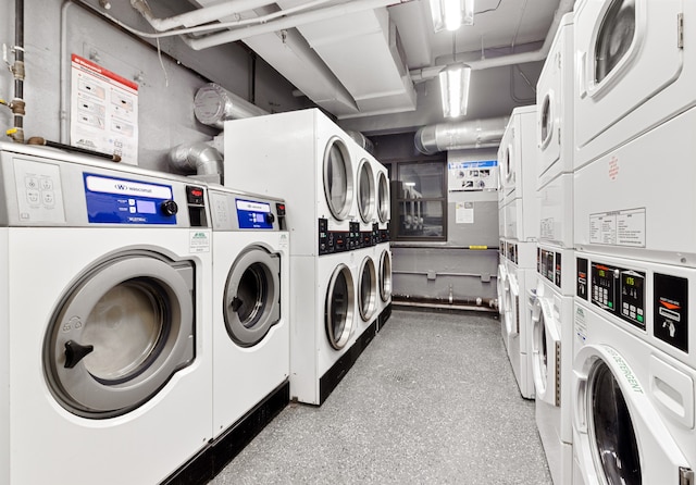 community laundry room featuring stacked washer and dryer and washing machine and clothes dryer