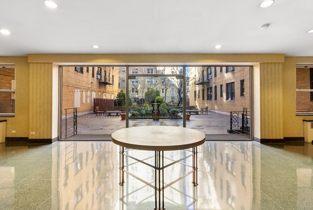 dining room with recessed lighting, granite finish floor, and baseboards