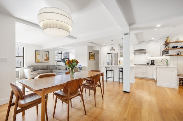 dining room with recessed lighting, radiator, and light wood finished floors