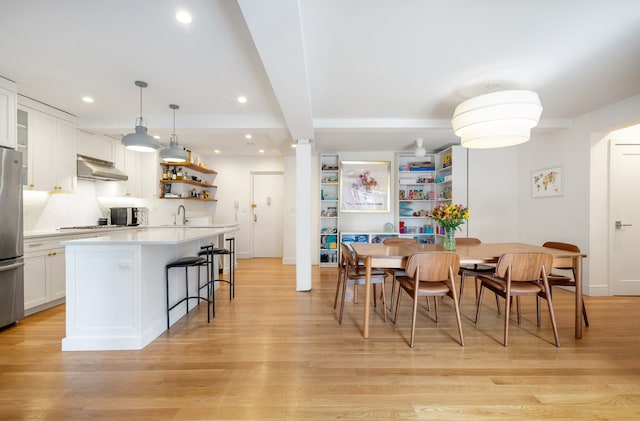 dining room featuring recessed lighting and light wood-style flooring