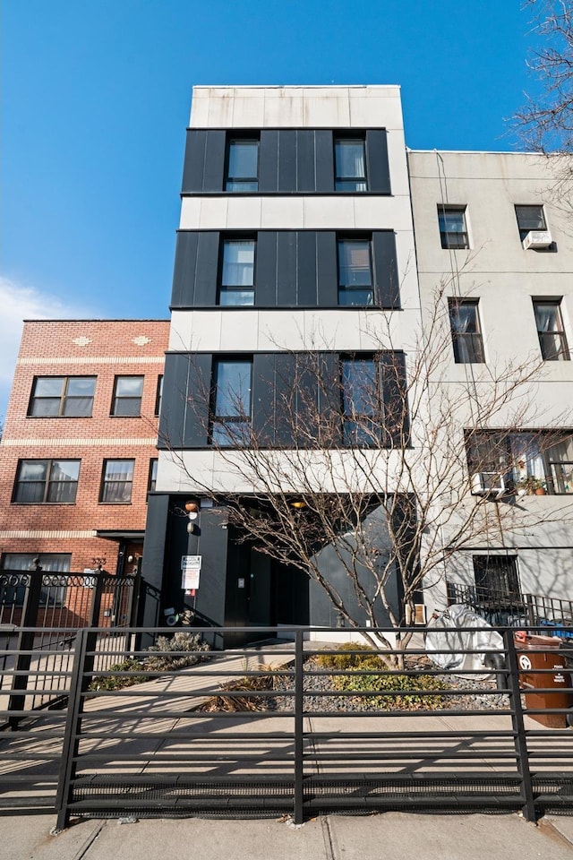 view of building exterior with fence