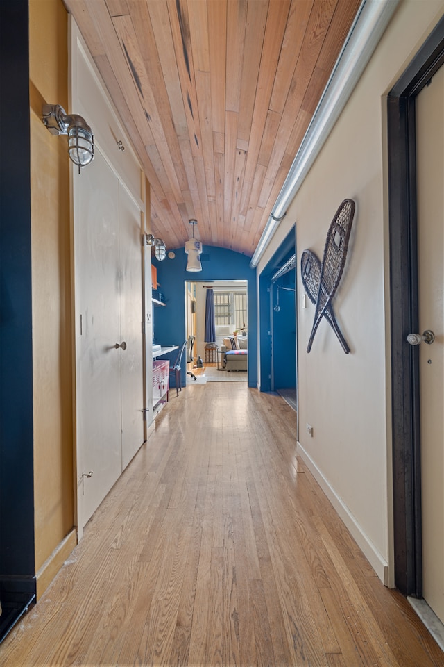 hall featuring wood ceiling, baseboards, vaulted ceiling, and wood finished floors