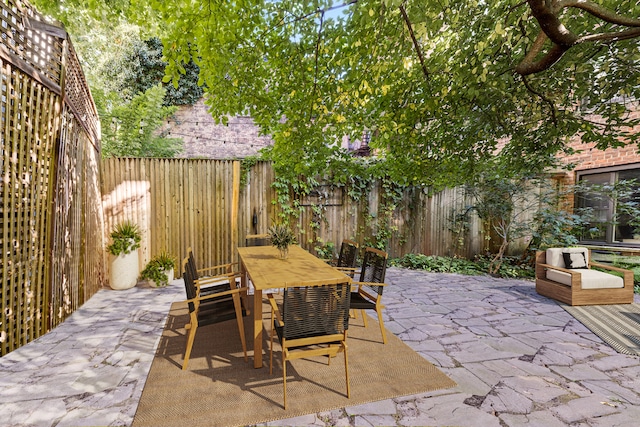 view of patio / terrace featuring outdoor dining area and a fenced backyard