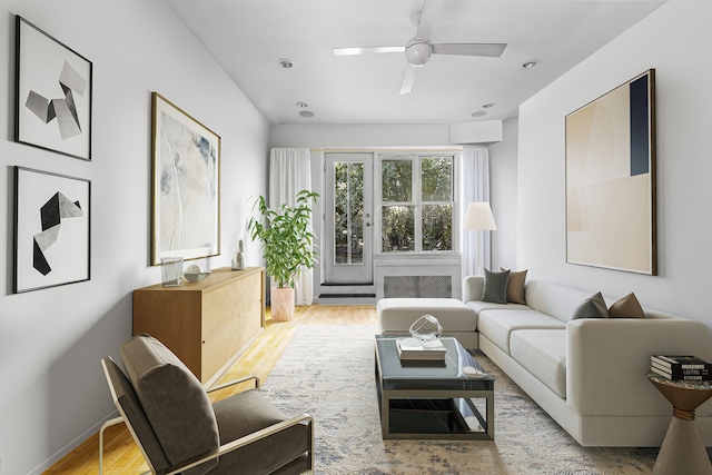 living area with ceiling fan, baseboards, baseboard heating, and wood finished floors