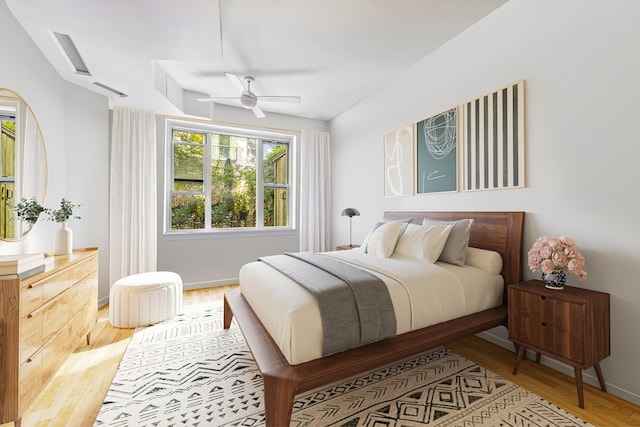 bedroom with a ceiling fan, baseboards, and wood finished floors