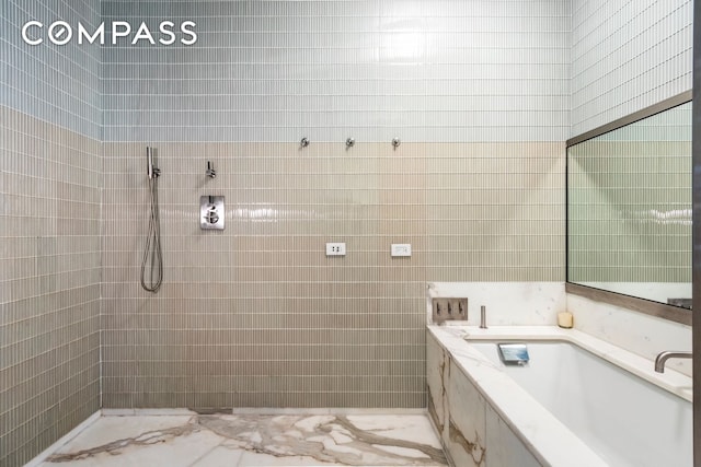 full bath featuring tile walls and a tile shower