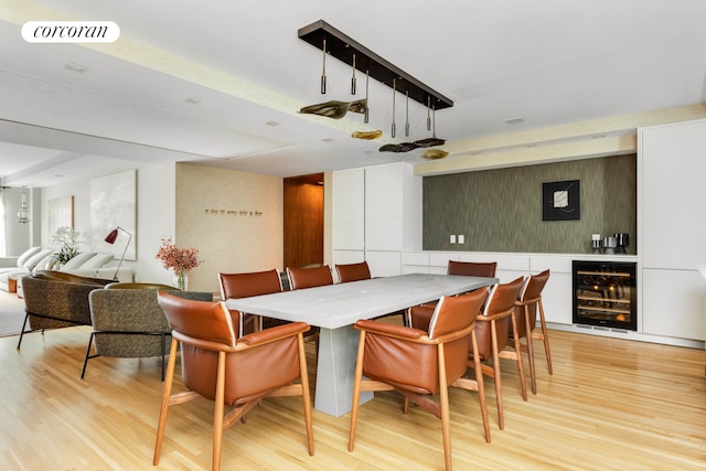 dining room with light wood-type flooring, wine cooler, and visible vents