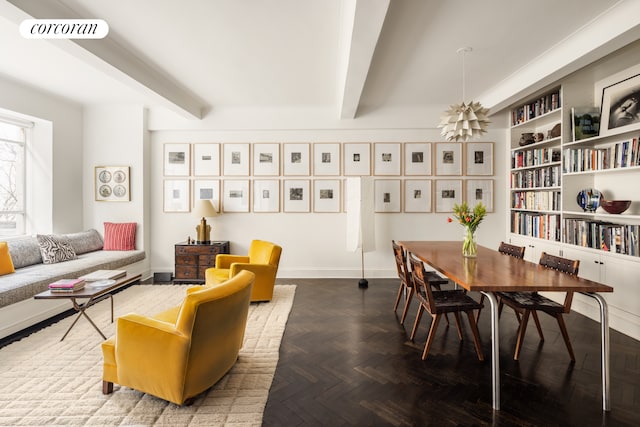 sitting room with visible vents, beam ceiling, and built in features