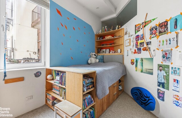 bedroom with carpet floors and multiple windows
