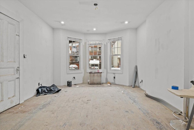 interior space with recessed lighting and radiator heating unit