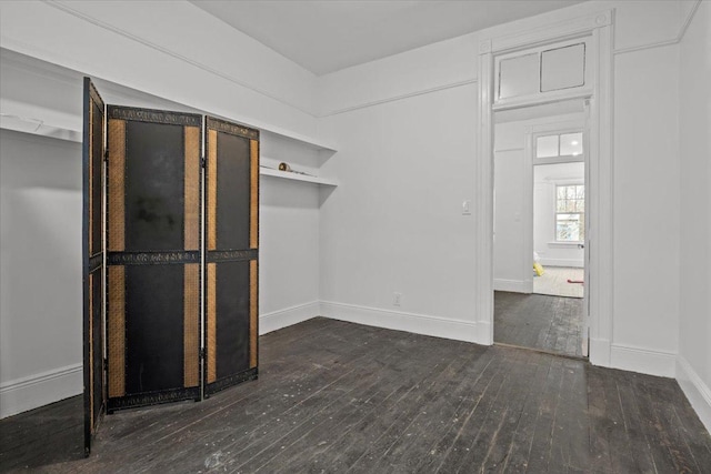 interior space featuring hardwood / wood-style flooring and baseboards