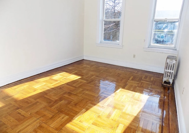 spare room featuring radiator heating unit and baseboards