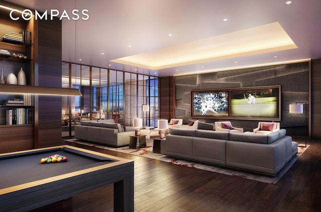 recreation room with pool table, a tray ceiling, and hardwood / wood-style floors