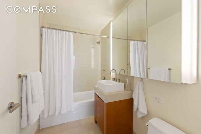 full bathroom featuring vanity, shower / tub combo, and toilet