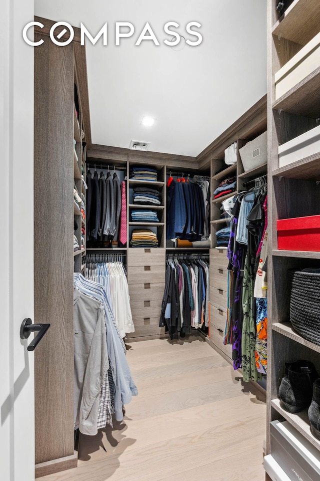 walk in closet featuring visible vents and wood finished floors