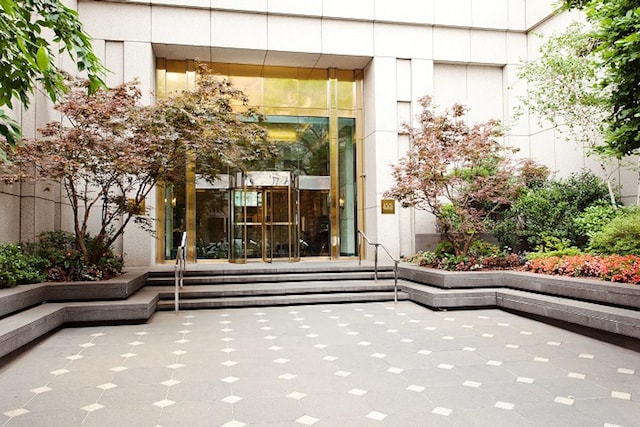 view of exterior entry featuring a patio