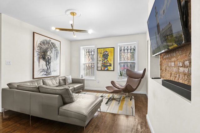 living area featuring baseboards and wood finished floors