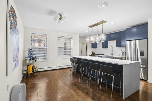 867 Lafayette Ave, New York City, NY 11221 - kitchen featuring stainless steel fridge, a sink, a breakfast bar area, a baseboard heating unit, and blue cabinets