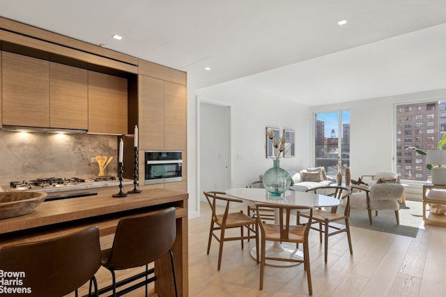 dining room featuring light wood-style flooring and recessed lighting