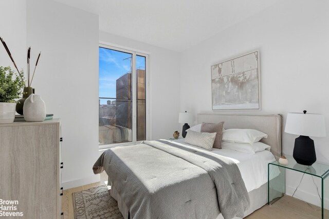 bedroom featuring baseboards and wood finished floors