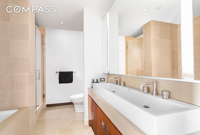 full bath featuring a bathtub, toilet, a shower stall, vanity, and tile patterned flooring