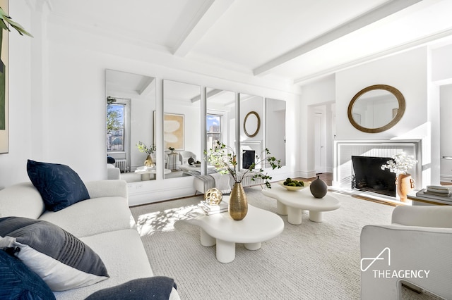 living area with beam ceiling and a fireplace
